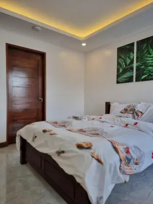 a bedroom with a large bed in a room at C Mary's Staycation in Tanza Cavite Condo Type with balcony good for 2 person in Tanza