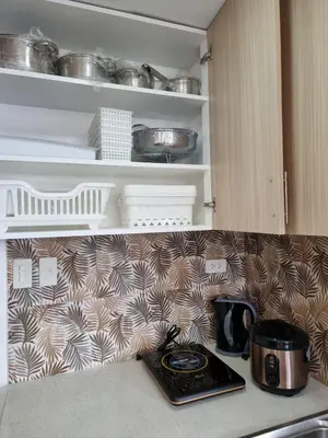 a kitchen with a stove and a counter top at C Mary's Staycation in Tanza Cavite Condo Type with balcony good for 2 person in Tanza