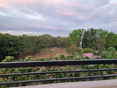 a view of a garden from a bench at C Mary's Staycation in Tanza Cavite Condo Type with balcony good for 2 person in Tanza