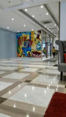 a lobby with a painting on the wall and a chair at ADB AVENUE TOWER in Manila