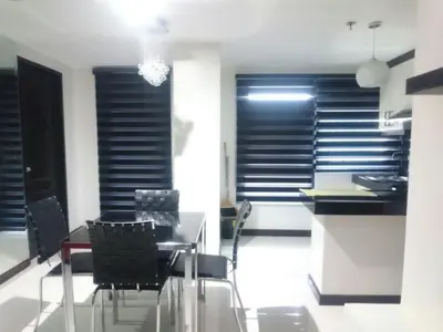 a dining room with a table and chairs at ADB AVENUE TOWER in Manila
