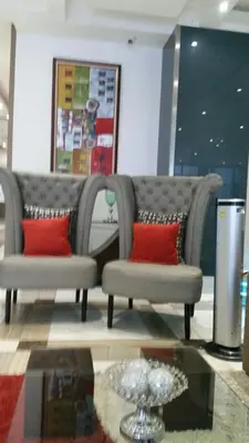 a couch with two red pillows in a room at ADB AVENUE TOWER in Manila