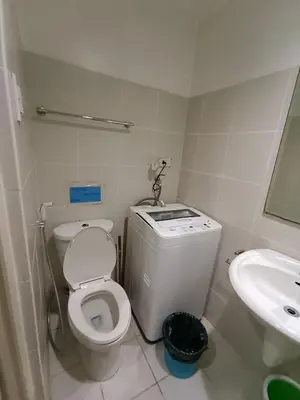 a small bathroom with a toilet and a sink at 1BR SEA RESIDENCE by ABBY in Manila