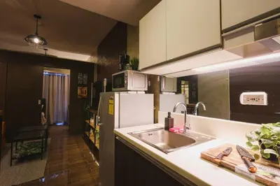 a kitchen with a sink and a refrigerator at Kensal Industrial - Air Residences in Manila