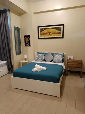 a bedroom with a bed with towels on it at Rj Condotel Near Naia Terminal 3 in Manila