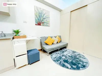 a living room with a couch and a table at Happy Stay in Manila