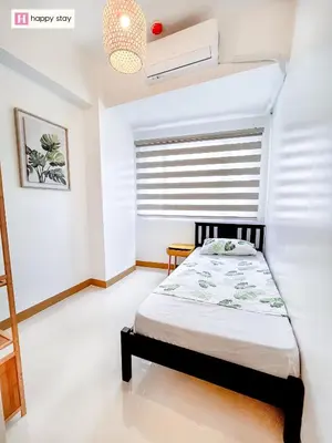 a bedroom with a bed and a window at Happy Stay in Manila