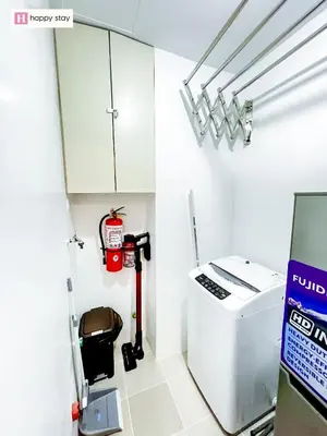 a room with a white cabinet and a water heater at Happy Stay in Manila