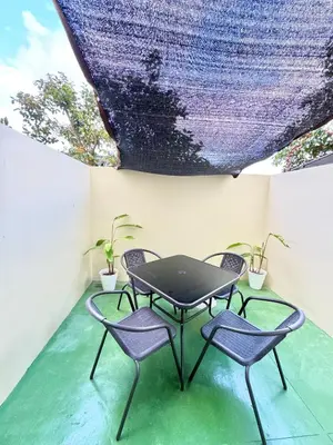 a table and two chairs on a patio at Fullerton Suites in Puting Kahoy