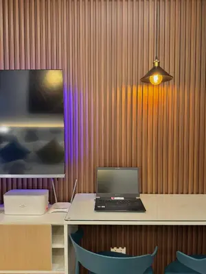 a laptop computer sitting on a desk in a room at Fullerton Suites in Puting Kahoy