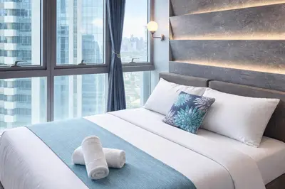 a hotel room with a bed with a large window at 37 BGC Prime Suite across Uptown Mall & Mitsukoshi Mall FREE Parking in Manila