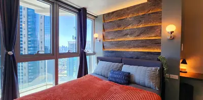a bedroom with a bed and a large window at 37 BGC Prime Suite across Uptown Mall & Mitsukoshi Mall FREE Parking in Manila