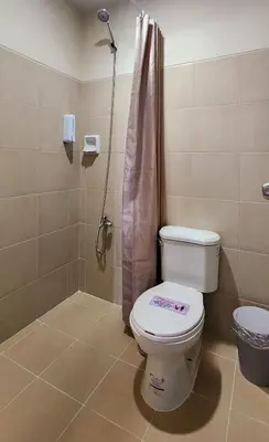 a bathroom with a toilet and a shower at 37 BGC Prime Suite across Uptown Mall & Mitsukoshi Mall FREE Parking in Manila