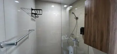 a bathroom with a shower with a glass door at 37 BGC Prime Suite across Uptown Mall & Mitsukoshi Mall FREE Parking in Manila