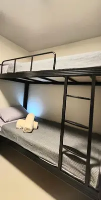 a room with two bunk beds in a room at 37 BGC Prime Suite across Uptown Mall & Mitsukoshi Mall FREE Parking in Manila