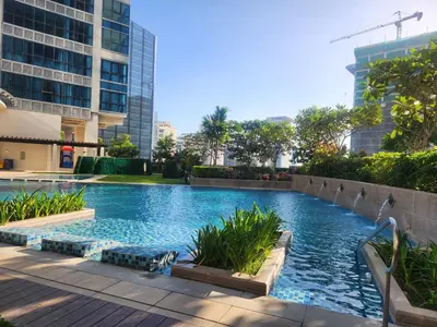 a swimming pool in the middle of a building at 37 BGC Prime Suite across Uptown Mall & Mitsukoshi Mall FREE Parking in Manila