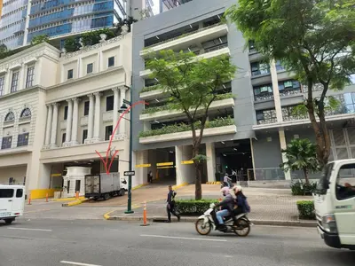 two people riding motorcycles in front of a building at 37 BGC Prime Suite across Uptown Mall & Mitsukoshi Mall FREE Parking in Manila
