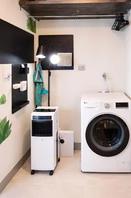a laundry room with a washing machine and a lamp at 37 BGC Prime Suite across Uptown Mall & Mitsukoshi Mall FREE Parking in Manila