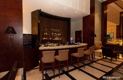 a bar in a restaurant with chairs and a bar counter at Makati Diamond Residences in Manila