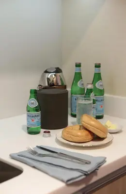 a table with a plate of food and bottles of soda at Makati Diamond Residences in Manila