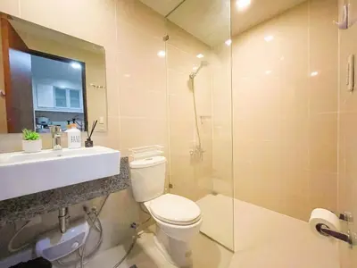 a bathroom with a toilet and a sink and a shower at Best BGC Condo Near Uptown Area #oursw30b2 in Manila