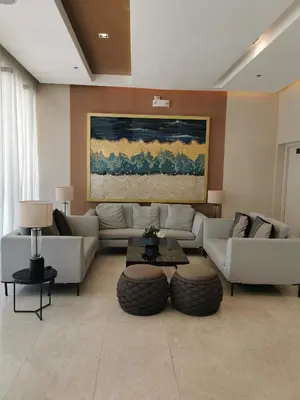 a living room with couches and tables and a painting at Shore 3 mall of Asia condotel in Manila