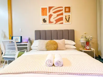 a bedroom with a bed with two towels on it at BGC Stay: Prime Condo AcrossGrand Hyatt #oursw32p in Manila