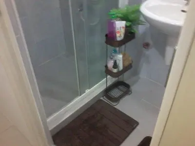 a bathroom with a shower and a sink at Sea Residences Holiday Rentals in Manila