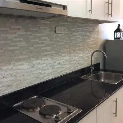 a kitchen with a sink and a counter top at Sea Residences Holiday Rentals in Manila