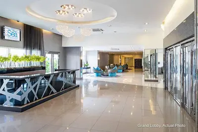 a lobby of a hotel with a large room with couches at Sea Residences Holiday Rentals in Manila
