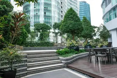 a garden with stairs and a table and chairs at Gora studio in Avant BGC parking with fee in Manila