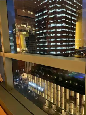 a view of a large building from a window at #31 One Uptown Residences BGC in Manila