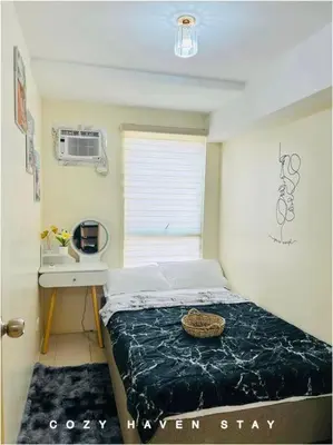 a small bedroom with a bed and a desk at #46 Urban Deca Homes Ortigas in Manila