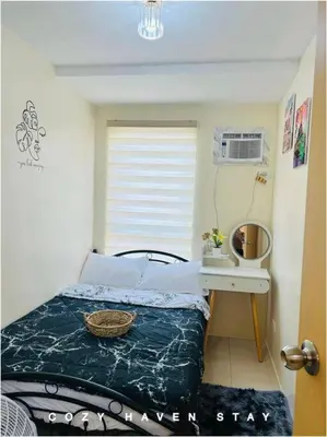 a small bedroom with a bed and a mirror at #46 Urban Deca Homes Ortigas in Manila