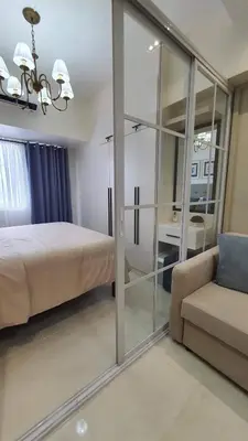 a bedroom with a bed and a couch at Luxury Condo with a view of Manila Bay in Manila