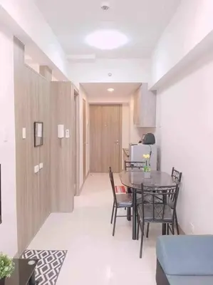 a dining room with a table and chairs in a room at #44 Coast Residences Tower1-20th in Manila