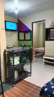a living room with a tv on the wall at Dencios Transient in Cabuyao