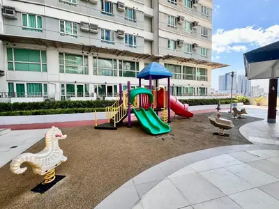 a playground in front of a building with a slide at Modern 2BR in Central Makati! Netflix Wi-Fi Pool in Manila