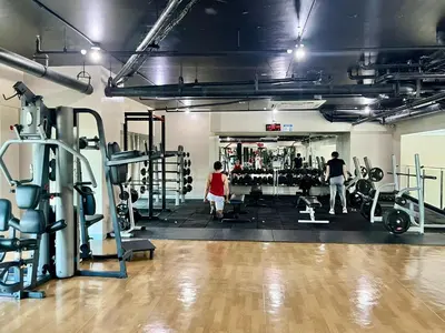 a gym with two people working out in the gym at Modern 2BR in Central Makati! Netflix Wi-Fi Pool in Manila