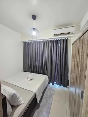 a bedroom with a bed and a window with at D' Shore Line - Shore Residences MOA PASAY in Manila