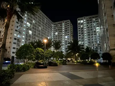 a city square at night with tall buildings at D' Shore Line - Shore Residences MOA PASAY in Manila