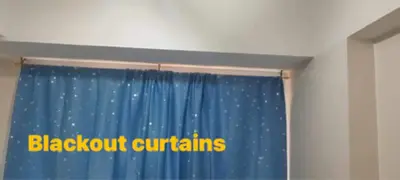 a blue curtain with the words blackfoot curlins on it at Solemare Parksuites Condominium in Manila