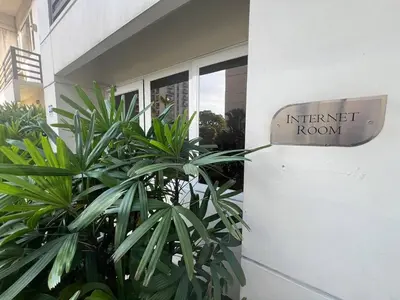 a sign on the side of a building that reads internet room at Solemare Parksuites Condominium in Manila