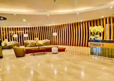 a lobby with a couch and a table in a room at 2 Condos, 5 Beds, 2 CR @ Shore2 MOA (3rd&5th Flrs) in Manila