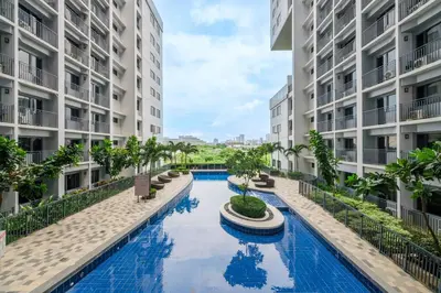 an image of a swimming pool in the middle of two apartment buildings at 2 Condos, 5 Beds, 2 CR @ Shore2 MOA (3rd&5th Flrs) in Manila