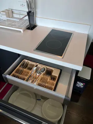 a drawer in a refrigerator with utensils in it at Acqua Private Residences - Livingstone Tower (Makati - Mandaluyong) in Manila