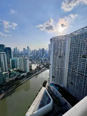a view of a city with a river and buildings at Acqua Private Residences - Livingstone Tower (Makati - Mandaluyong) in Manila