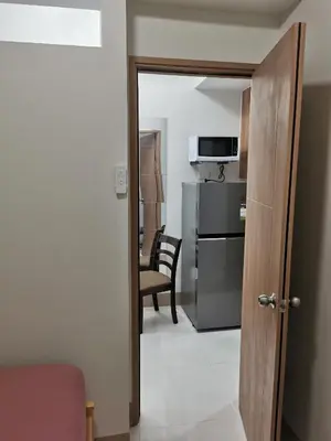 a door to a room with a kitchen and a microwave at Mall of Asia shore 3 tower 2 condotel in Manila