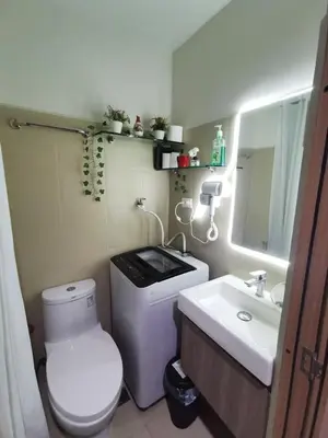 a bathroom with a white toilet and a sink at Mall of Asia shore 3 tower 2 condotel in Manila