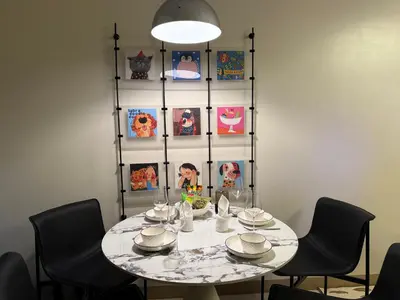 a dining room table with chairs and a light fixture at Luxurious 1 Br Facing Manila Bay Sunset Nearby Okada MOA Solaire Ayala Malls in Manila